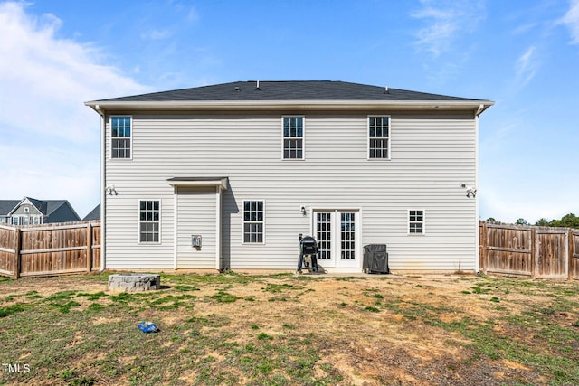 rear view of property with a yard