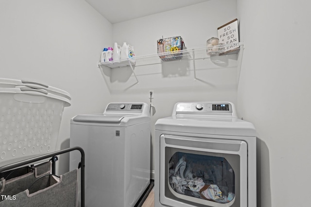 laundry area featuring washing machine and clothes dryer