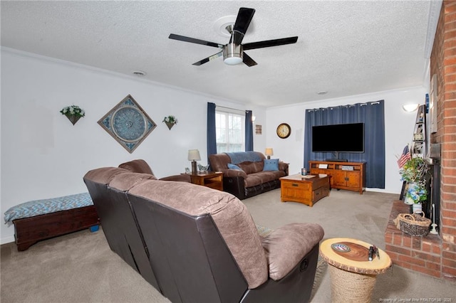 living room with ceiling fan, ornamental molding, a textured ceiling, light carpet, and a brick fireplace