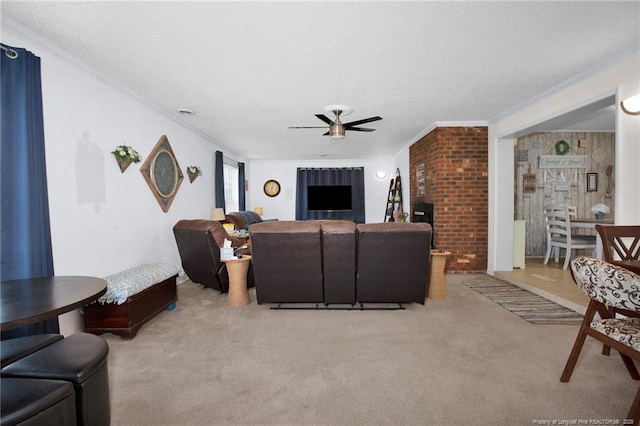 living room with light carpet, ceiling fan, crown molding, and a textured ceiling