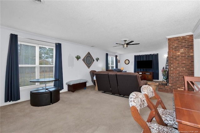 living room featuring crown molding, ceiling fan, light carpet, and a textured ceiling