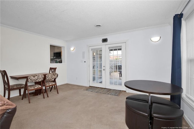 interior space with light carpet, crown molding, french doors, and a textured ceiling