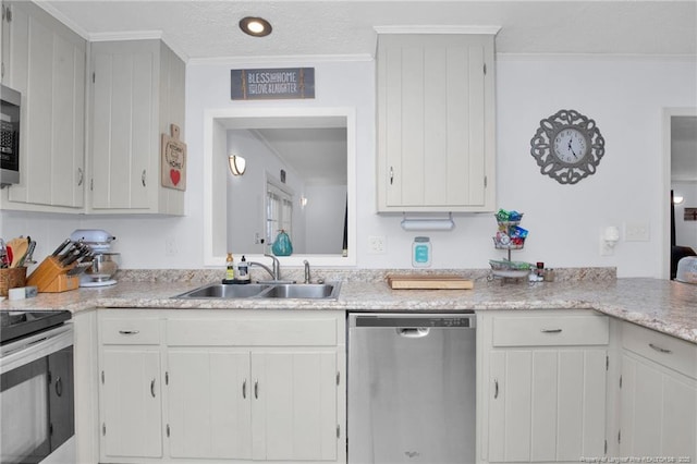 kitchen with stainless steel appliances, white cabinetry, and sink