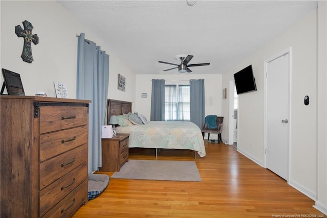 bedroom with ceiling fan and light wood-type flooring