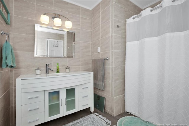 bathroom with vanity, wood-type flooring, tile walls, and curtained shower