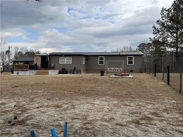 rear view of property featuring a wooden deck and a gazebo