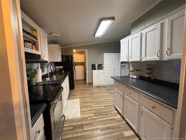 kitchen with white cabinets, white microwave, sink, and stainless steel range with electric cooktop