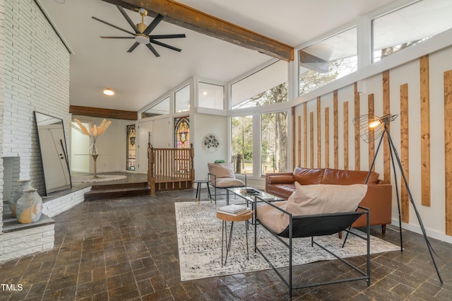 sunroom with lofted ceiling with beams, a brick fireplace, and ceiling fan