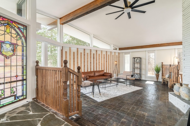 interior space featuring vaulted ceiling with beams and ceiling fan