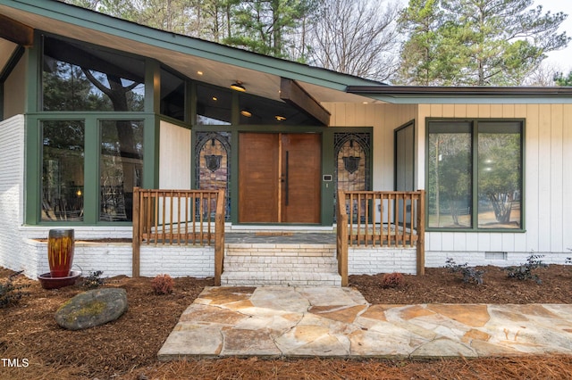 doorway to property featuring crawl space and covered porch