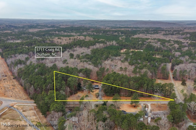 birds eye view of property with a forest view