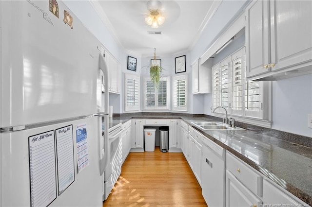 kitchen featuring sink, ornamental molding, white appliances, light hardwood / wood-style floors, and white cabinets