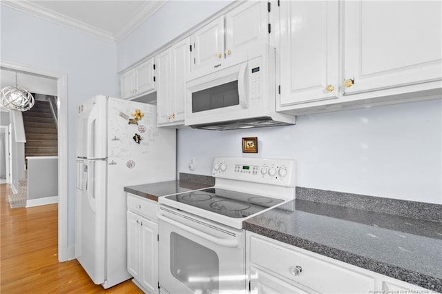 kitchen with white appliances, ornamental molding, light wood-type flooring, and white cabinets