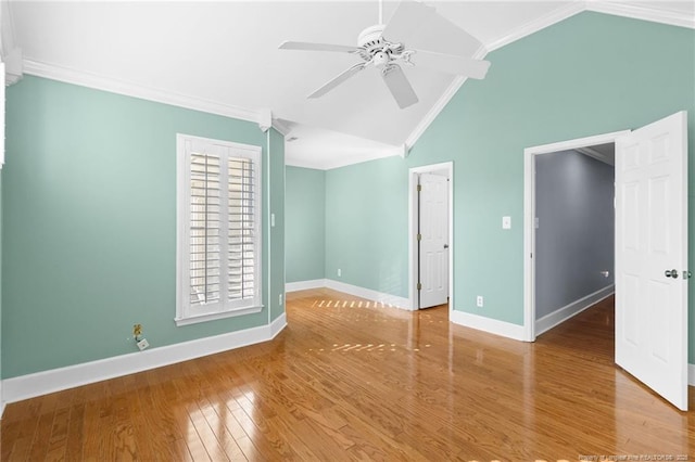 spare room featuring hardwood / wood-style flooring, ceiling fan, ornamental molding, and vaulted ceiling