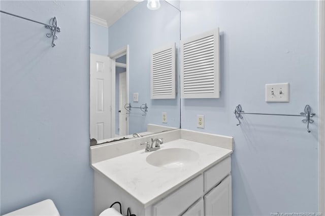 bathroom with vanity and ornamental molding