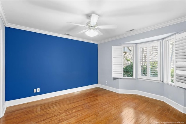 spare room with crown molding, ceiling fan, and wood-type flooring