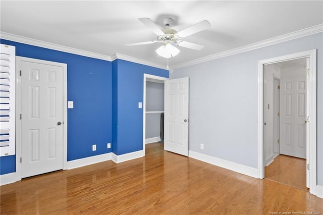 unfurnished bedroom featuring wood-type flooring, ceiling fan, and crown molding