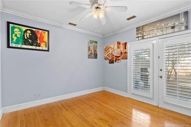 unfurnished room featuring hardwood / wood-style floors, ornamental molding, and ceiling fan