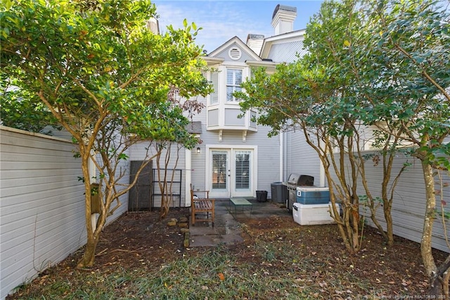 rear view of property with french doors