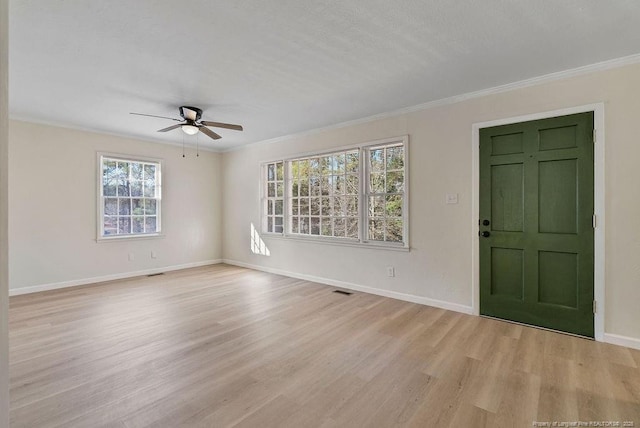 entryway with crown molding, ceiling fan, and light wood-type flooring