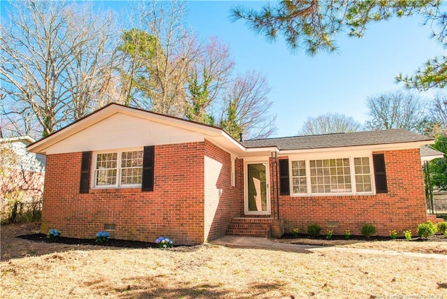 view of front facade with entry steps, brick siding, and crawl space