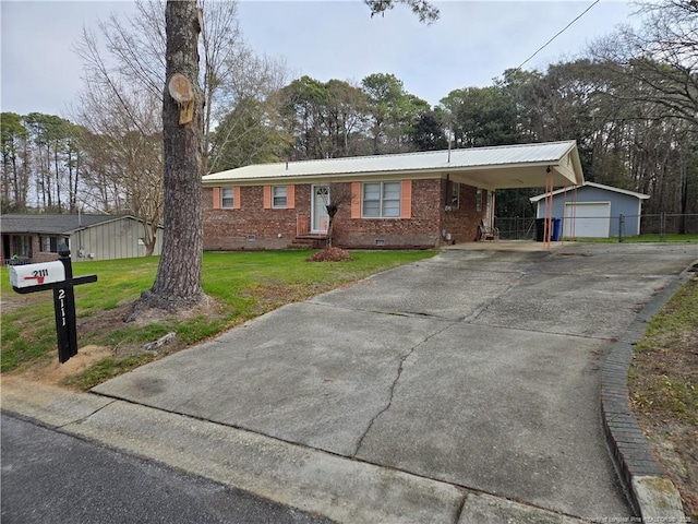 ranch-style house with an outbuilding, a carport, a garage, and a front lawn