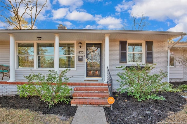 doorway to property featuring covered porch