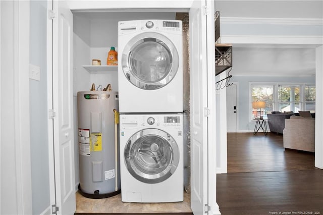 laundry area with ornamental molding, stacked washer / dryer, electric water heater, and hardwood / wood-style floors