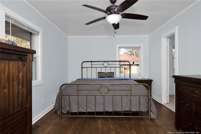 bedroom featuring ornamental molding, dark hardwood / wood-style floors, and ceiling fan