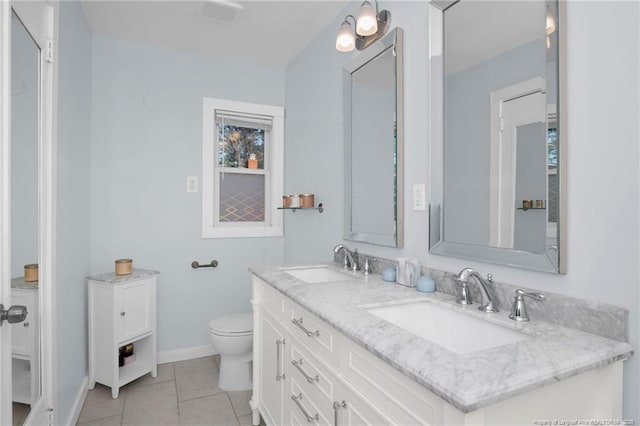 bathroom with vanity, tile patterned flooring, and toilet