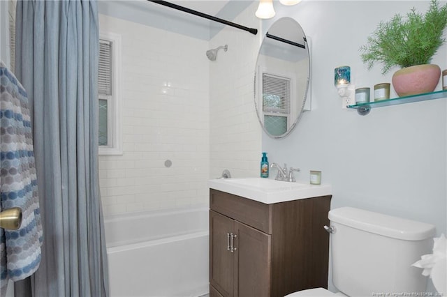 full bathroom with vanity, shower / bath combo with shower curtain, and toilet