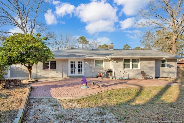 rear view of property featuring a patio and french doors