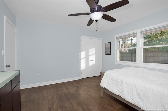 bedroom with dark wood-type flooring and ceiling fan