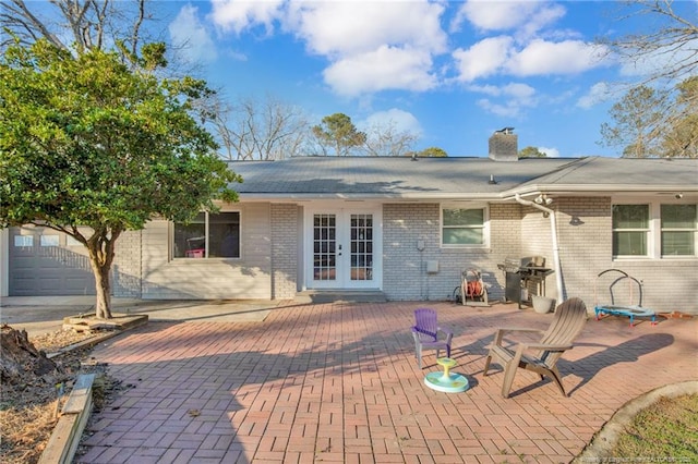 rear view of property featuring a patio area and french doors