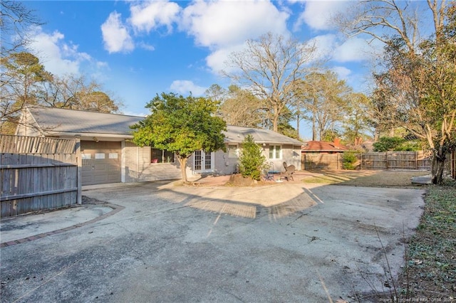 back of property with a garage