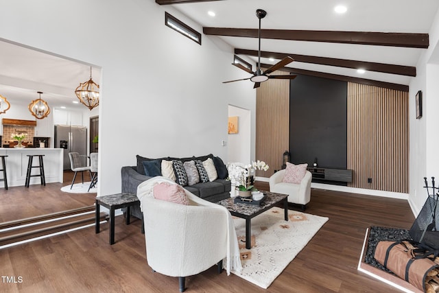 living room featuring beamed ceiling, high vaulted ceiling, dark hardwood / wood-style floors, and ceiling fan with notable chandelier