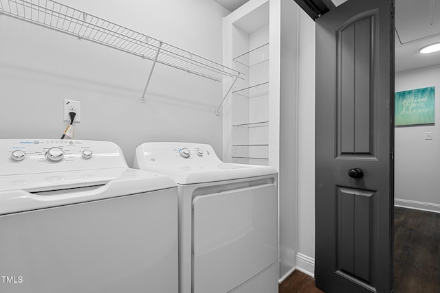 laundry area with dark wood-type flooring and washer and clothes dryer