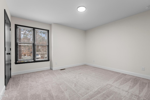 empty room with light colored carpet