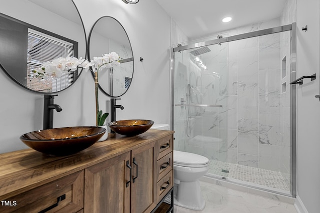 bathroom with vanity, toilet, and a shower with shower door