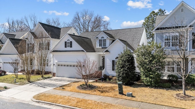 view of front of home with concrete driveway, a shingled roof, and an attached garage