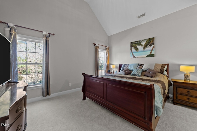 bedroom with high vaulted ceiling, light colored carpet, visible vents, and baseboards