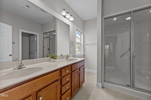 full bath featuring double vanity, visible vents, a sink, a shower stall, and tile patterned flooring