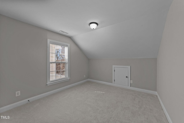 bonus room featuring vaulted ceiling, carpet, visible vents, and baseboards