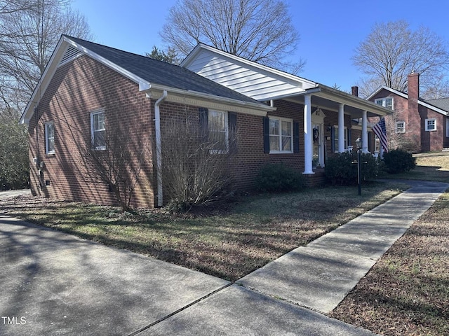 view of side of home featuring a yard