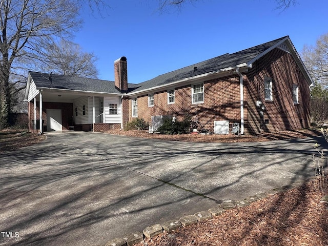 back of property featuring a carport