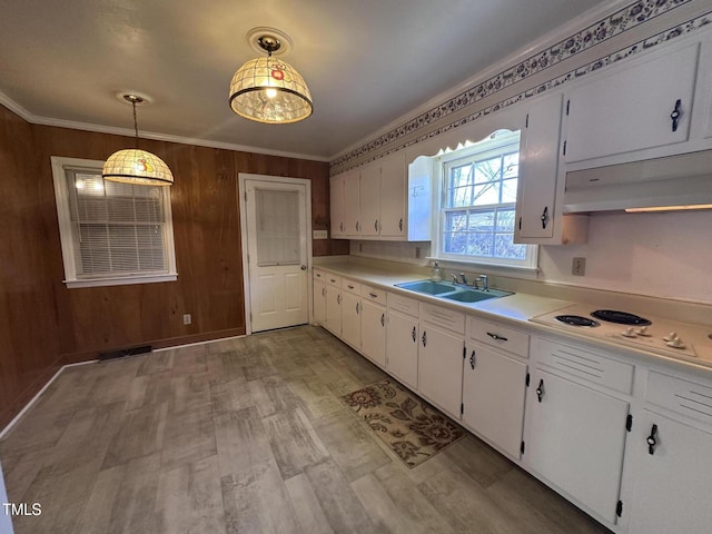 kitchen featuring sink, hanging light fixtures, ornamental molding, white cabinets, and white electric stovetop