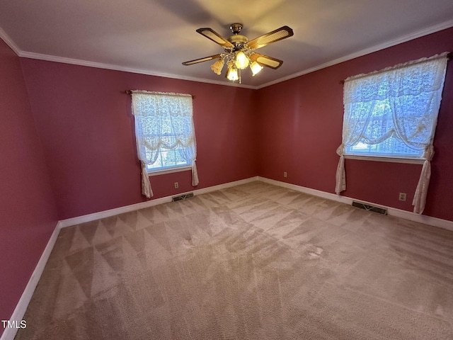 carpeted empty room with ornamental molding and ceiling fan