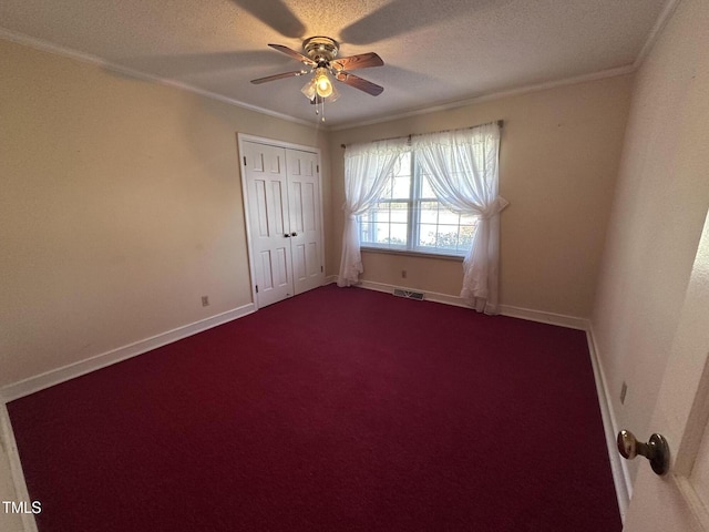 unfurnished room featuring crown molding, ceiling fan, carpet, and a textured ceiling