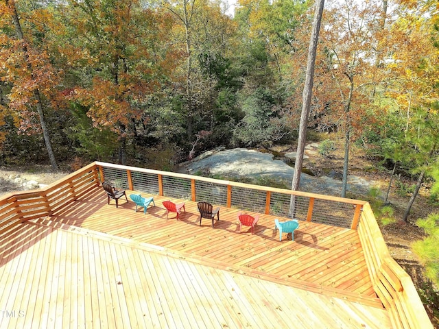 wooden deck featuring a wooded view