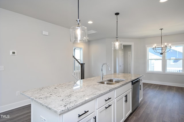 kitchen with decorative light fixtures, dishwasher, sink, white cabinets, and a kitchen island with sink